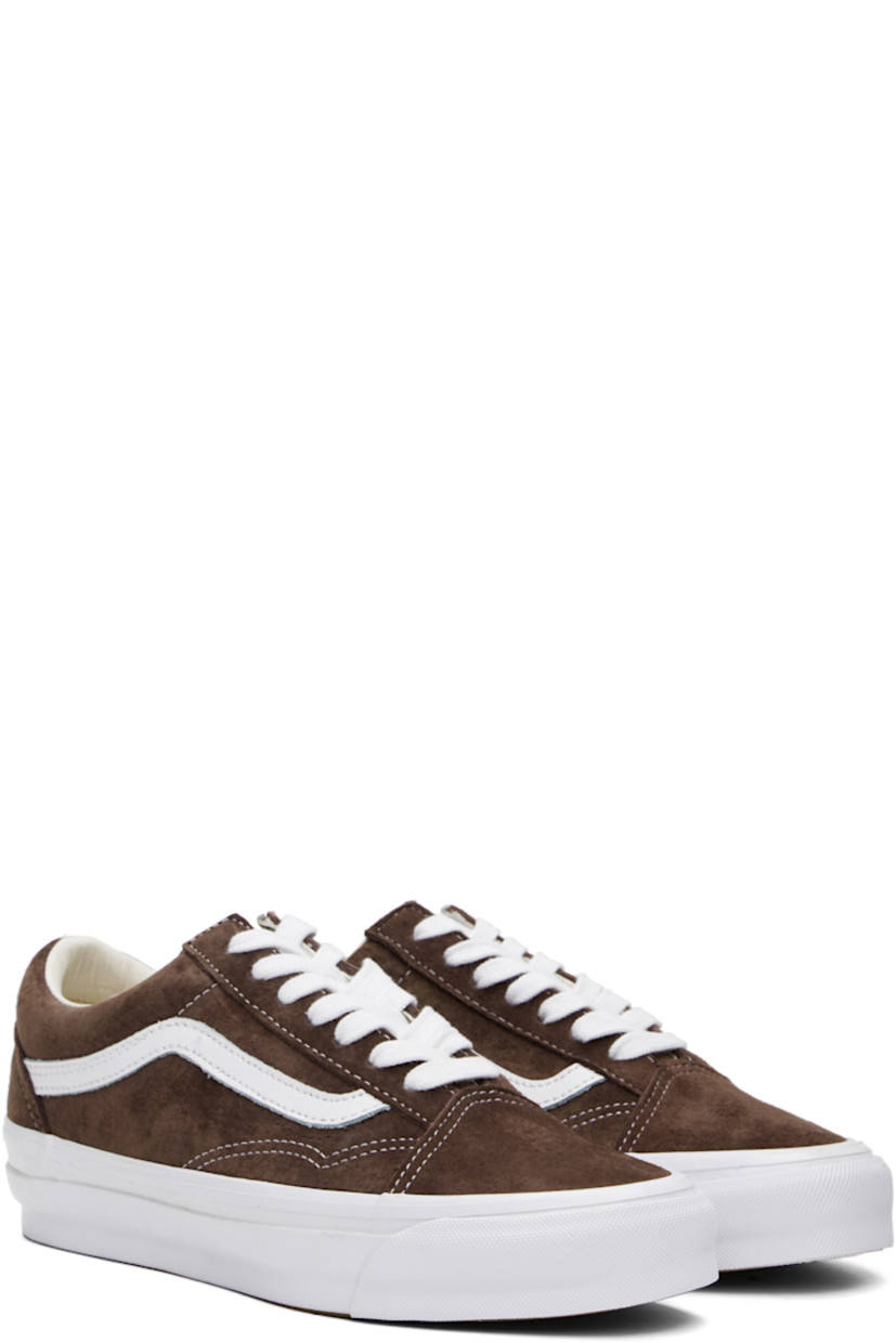 Low-top pigskin suede sneakers in brown. 

· Lace-up closure
· Padded tongue and collar
· Grained leather Sidestripe™ at sides
· Padded Sola ADC foam footbed
· Grained leather and canvas lining
· Rubberized logo patch at heel
· Treaded rubber sole
· Contrast stitching in white

Supplier color: Pig suede potting soil