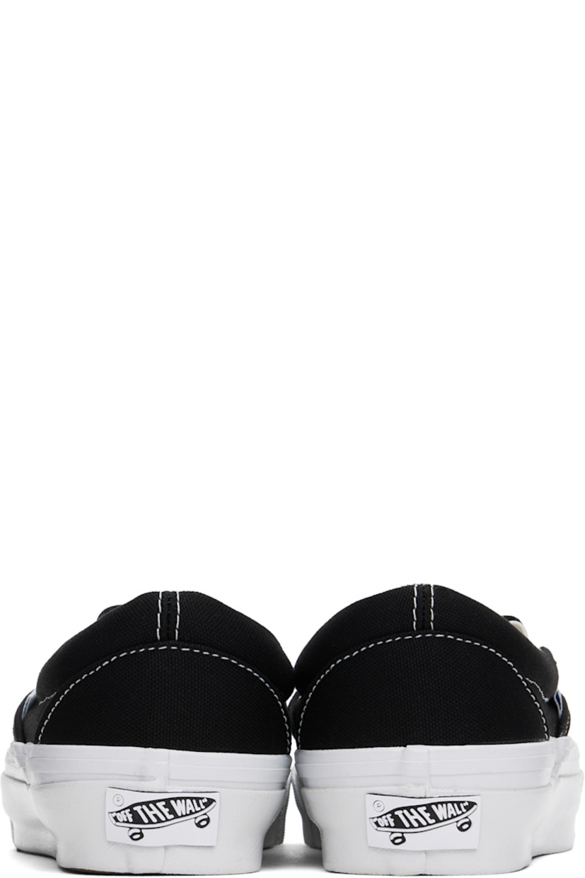 Low-top slip-on canvas sneakers in black. 

· Elasticized gussets at tongue
· Padded collar
· Logo flag at outer side
· Padded Sola ADC foam footbed
· Grained leather and canvas lining
· Rubberized logo patch at heel
· Treaded rubber sole
· Contrast stitching in white

Supplier color: Black/White