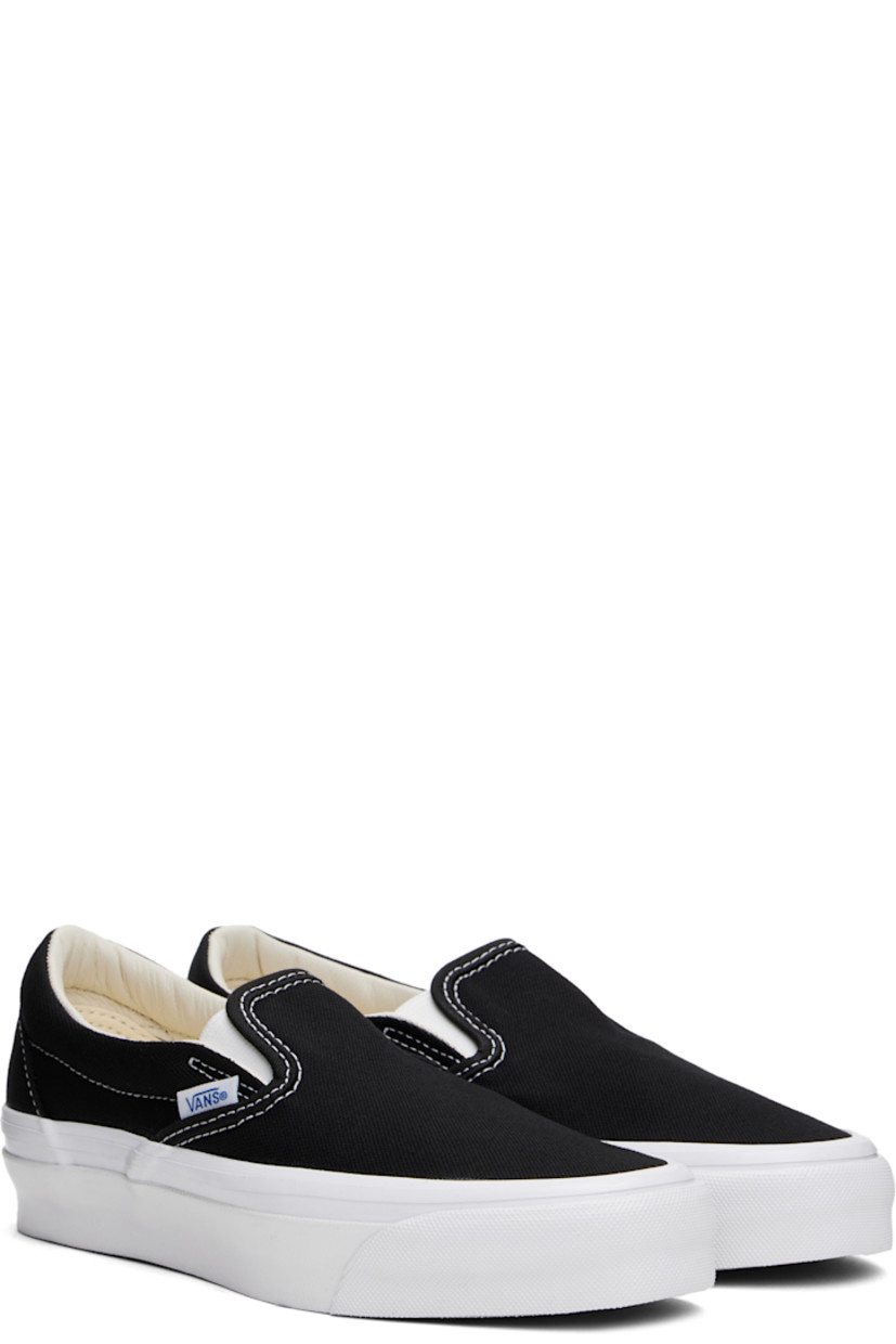 Low-top slip-on canvas sneakers in black. 

· Elasticized gussets at tongue
· Padded collar
· Logo flag at outer side
· Padded Sola ADC foam footbed
· Grained leather and canvas lining
· Rubberized logo patch at heel
· Treaded rubber sole
· Contrast stitching in white

Supplier color: Black/White