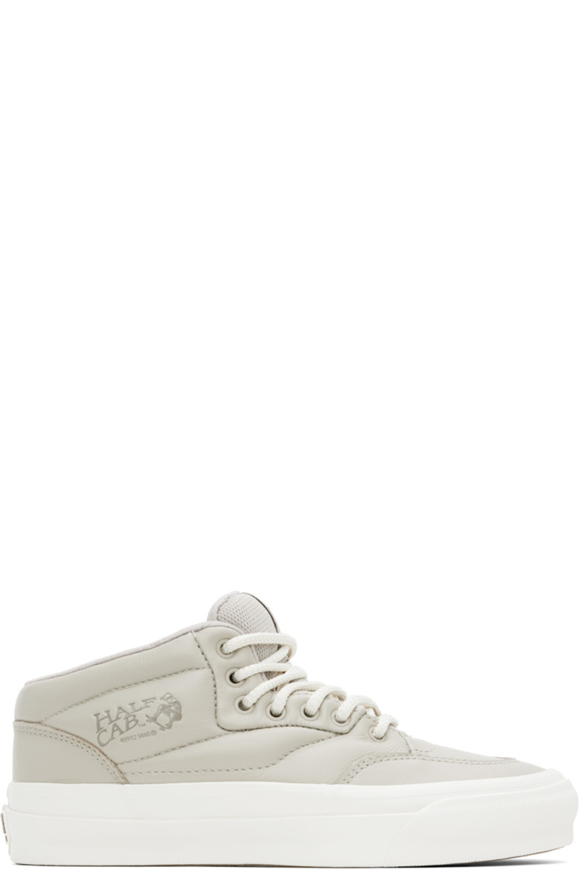Mid-top buffed leather sneakers in gray.

· Lace-up closure
· Logo patch at padded tongue
· Padded collar
· Logo embossed at outer side
· Mesh lining
· Rubberized logo patch at heel
· Treaded rubber sole

Supplier color: Warm grey