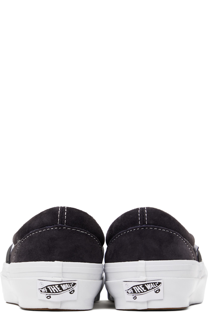 Low-top pigskin suede slip-on sneakers in navy.

· Elasticized gussets at vamp
· Padded collar
· Logo flag at outer side
· Rubberized logo patch at heel
· Grained leather and canvas lining
· Treaded rubber sole
· Contrast stitching in white

Supplier color: Pig suede nine iron