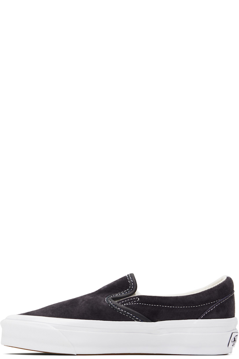 Low-top pigskin suede slip-on sneakers in navy.

· Elasticized gussets at vamp
· Padded collar
· Logo flag at outer side
· Rubberized logo patch at heel
· Grained leather and canvas lining
· Treaded rubber sole
· Contrast stitching in white

Supplier color: Pig suede nine iron