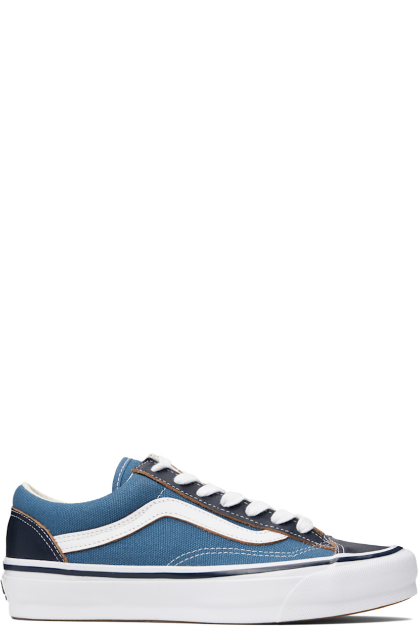 Low-top canvas and grained leather sneakers in blue and brown. 

· Lace-up closure
· Padded tongue and collar
· Grained leather Sidestripe™ at sides
· Rubberized logo patch at heel
· Treaded Vibram® rubber sole
· Contrast stitching in white

Supplier color: STV navy