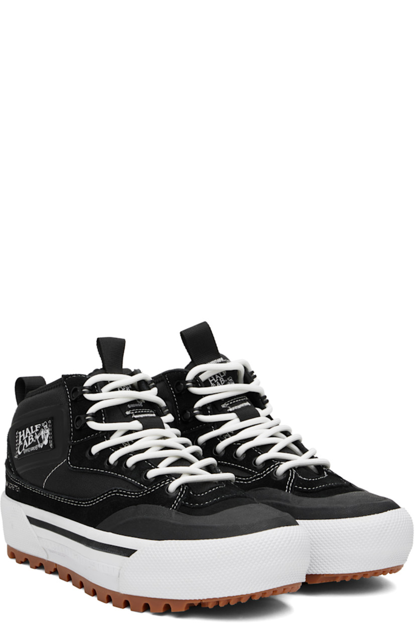 Mid-top canvas and suede sneakers in black and white.

· GORE-TEX® Duratherm-insulated
· Waterproof
· Textured rubber cap toe
· Lace-up closure
· Logo patch at padded tongue and outer side
· Pull-loop at tongue and heel collar
· UltraCush™ molded footbed
· Fleece lining
· Rubberized logo patch at heel midsole
· All-Trac treaded rubber sole

Supplier color: Black/White