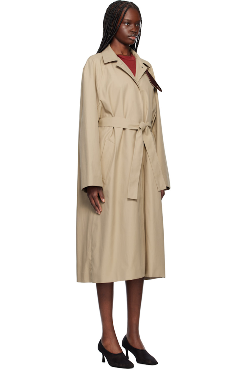 Polyester- and cotton-blend gabardine coat. 

· Detachable button tab at stand collar
· Concealed button closure
· Welt pockets
· Detachable self-tie belt at waist
· Zip vents at side seams 
· Raglan sleeves
· Central vent at back hem
· Partial satin twill lining

Supplier color: Beige
