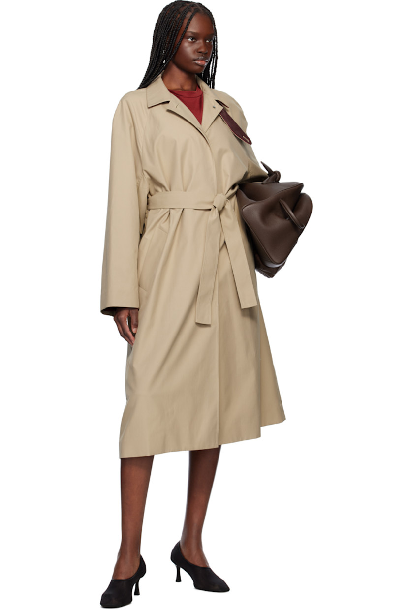 Polyester- and cotton-blend gabardine coat. 

· Detachable button tab at stand collar
· Concealed button closure
· Welt pockets
· Detachable self-tie belt at waist
· Zip vents at side seams 
· Raglan sleeves
· Central vent at back hem
· Partial satin twill lining

Supplier color: Beige