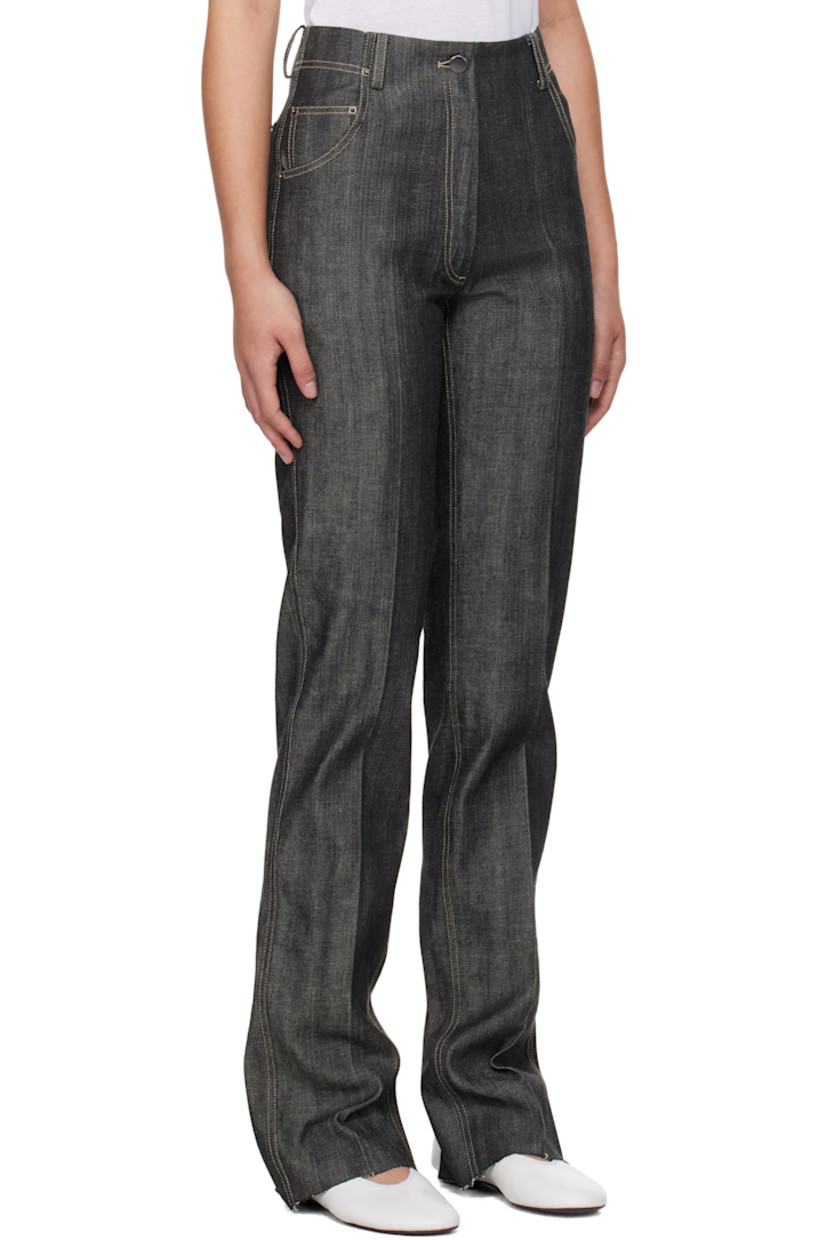 Non-stretch denim jeans. 

· Belt loops 
· Five-pocket styling 
· Zip-fly 
· Creased legs 
· Raw edge at cuffs
· Leather logo patch at back waistband 
· Vented cuffs at back 
· Contrast stitching in white

Supplier color: Indigo