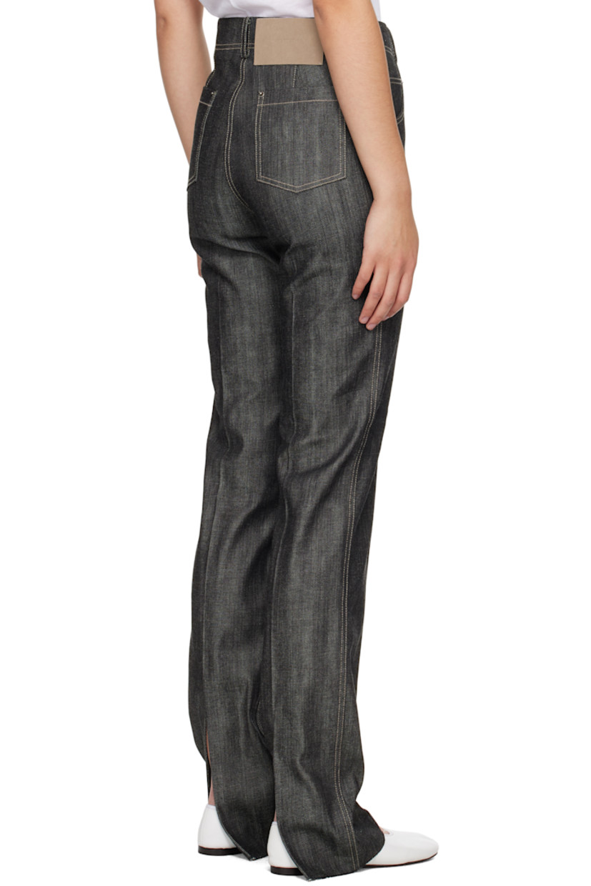 Non-stretch denim jeans. 

· Belt loops 
· Five-pocket styling 
· Zip-fly 
· Creased legs 
· Raw edge at cuffs
· Leather logo patch at back waistband 
· Vented cuffs at back 
· Contrast stitching in white

Supplier color: Indigo