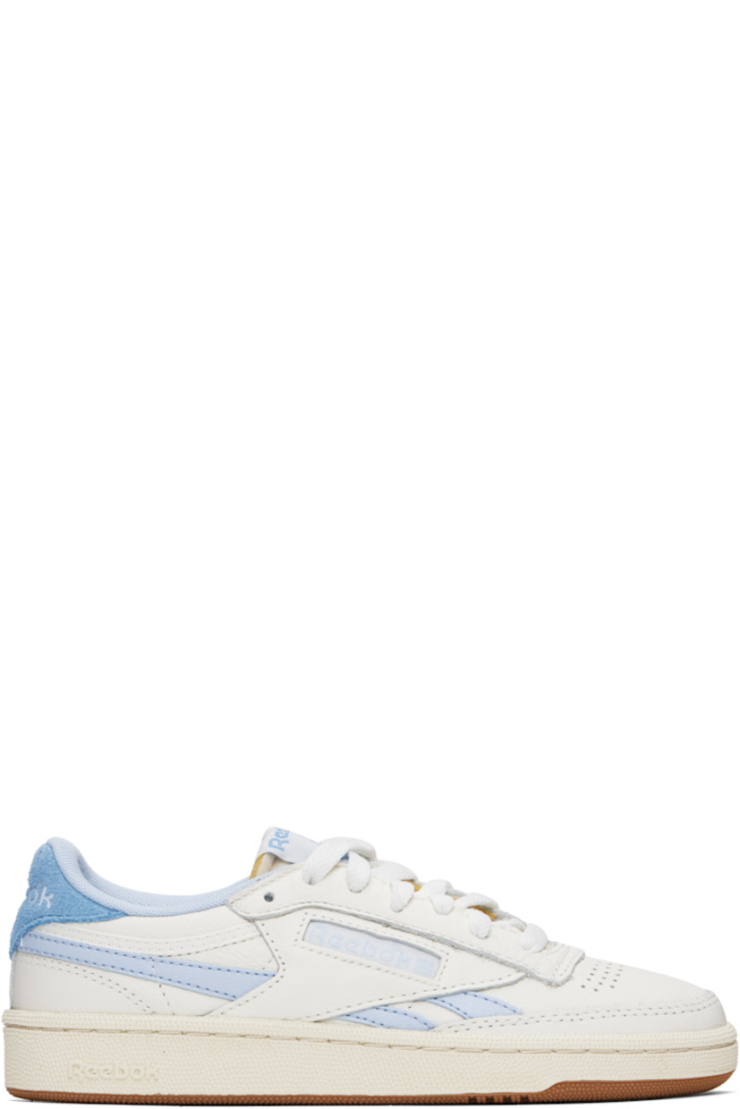Low-top grained leather sneakers in off-white and blue.

· Perforated detailing at toe
· Lace-up closure
· Logo patch at padded tongue
· Padded collar
· Inset logo patch at outer side
· Signature stripes at sides
· Logo embossed at suede heel tab
· Mesh lining
· Treaded rubber sole

Supplier color: Chalk/Y2kblue/Recoveryblue