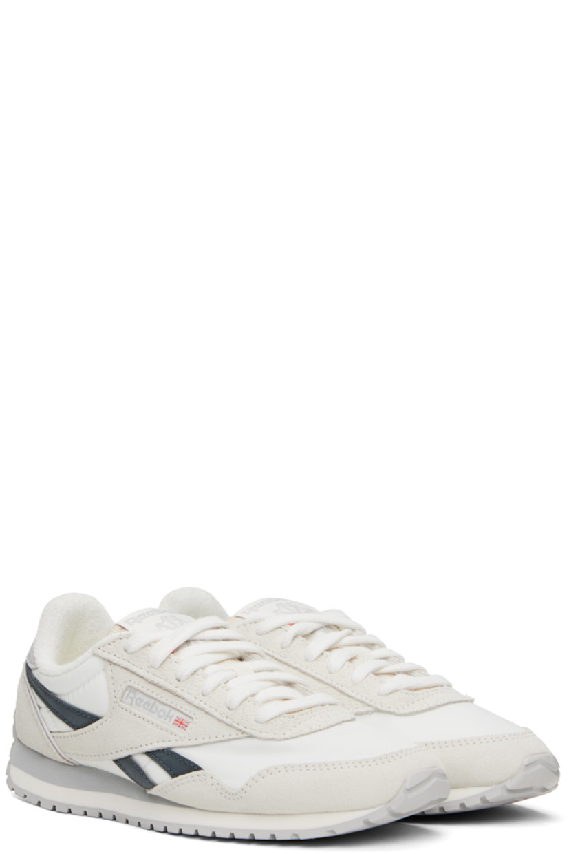 Low-top suede and canvas sneakers in white and gray.

· Lace-up closure
· Logo patch at padded tongue
· Padded collar
· Signature stripes at sides
· Inset logo patch at outer side
· Logo printed at heel tab
· Terrycloth lining
· Treaded rubber sole

Supplier color: Chalk/Chalk/Grey5