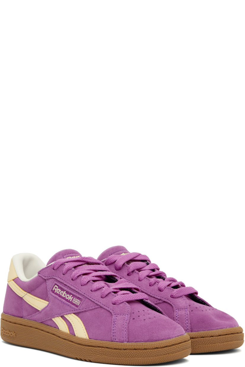 Low-top suede sneakers in purple.

· Perforated detailing at toe
· Lace-up closure
· Logo embossed at padded tongue
· Padded collar
· Inset logo patch at outer side
· Signature stripes at sides
· Logo embossed at heel tab
· Grained leather lining
· Logo embossed at textured rubber midsole
· Treaded rubber sole

Supplier color: Purplerave/Bleachedyellow/Chalk