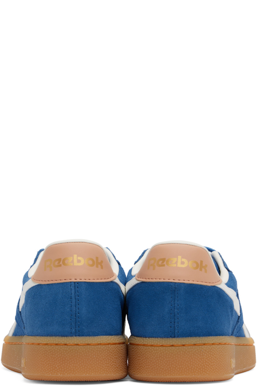 Low-top suede sneakers in blue.

· Buffed leather trim throughout
· Perforations at toe and inner side
· Lace-up closure
· Logo embossed at padded tongue
· Padded collar
· Inset logo patch at outer side
· Stripes at sides
· Logo printed at heel tab
· Buffed leather and mesh lining
· Logo embossed at crêpe-rubber midsole
· Treaded rubber sole

Supplier color: Twilight blue/Clay/Chalk