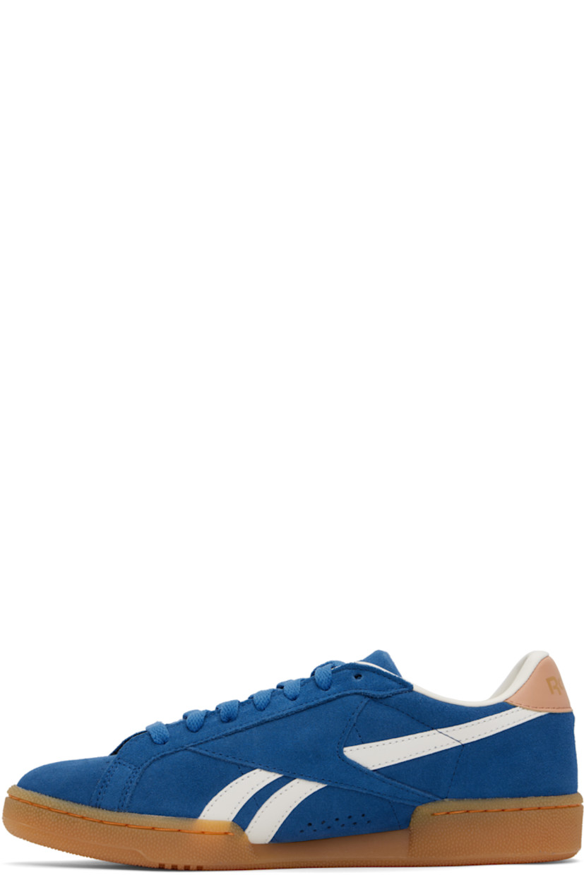Low-top suede sneakers in blue.

· Buffed leather trim throughout
· Perforations at toe and inner side
· Lace-up closure
· Logo embossed at padded tongue
· Padded collar
· Inset logo patch at outer side
· Stripes at sides
· Logo printed at heel tab
· Buffed leather and mesh lining
· Logo embossed at crêpe-rubber midsole
· Treaded rubber sole

Supplier color: Twilight blue/Clay/Chalk