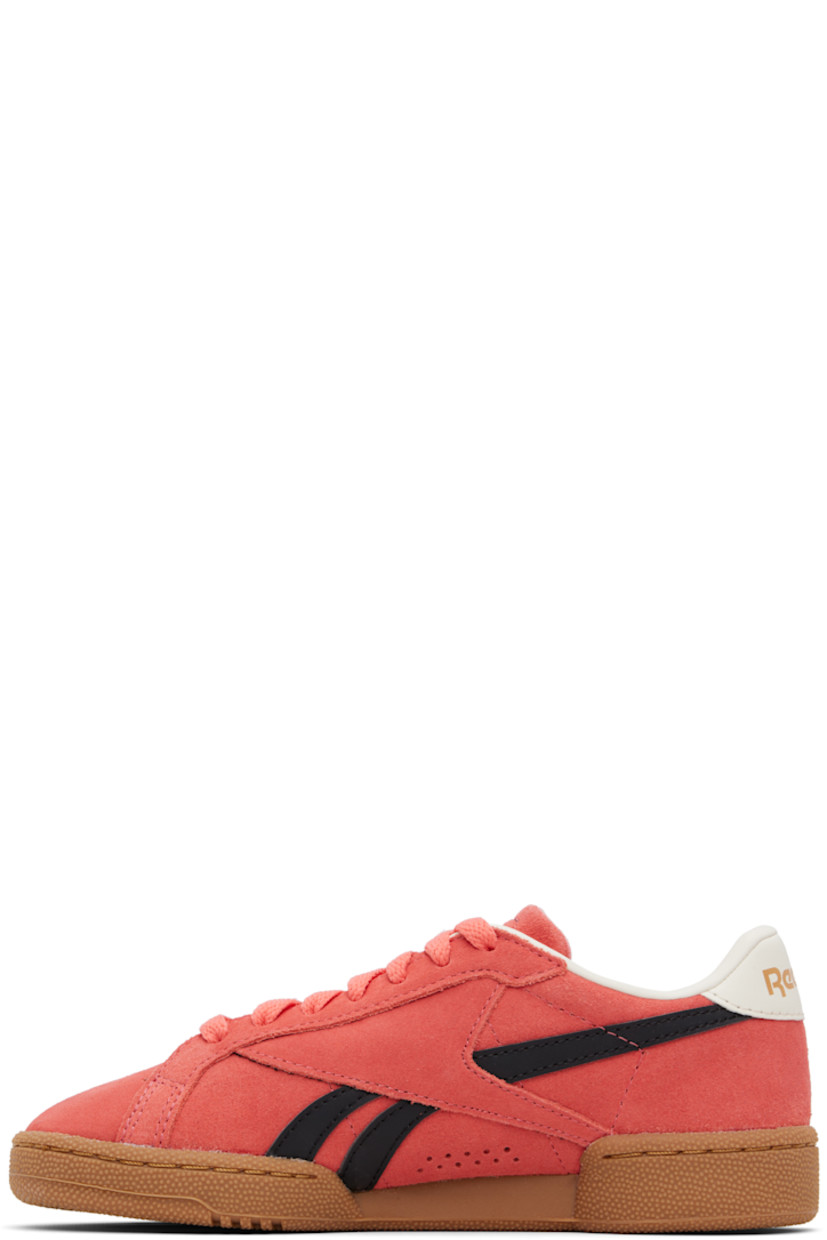 Low-top suede sneakers in pink.

· Perforated detailing at toe
· Lace-up closure
· Logo embossed at padded tongue
· Padded collar
· Inset logo patch at outer side
· Signature stripes at sides
· Logo printed at heel tab
· Mesh and grained leather lining
· Treaded rubber sole

Supplier color: Sunsetcoral/Black/Gum