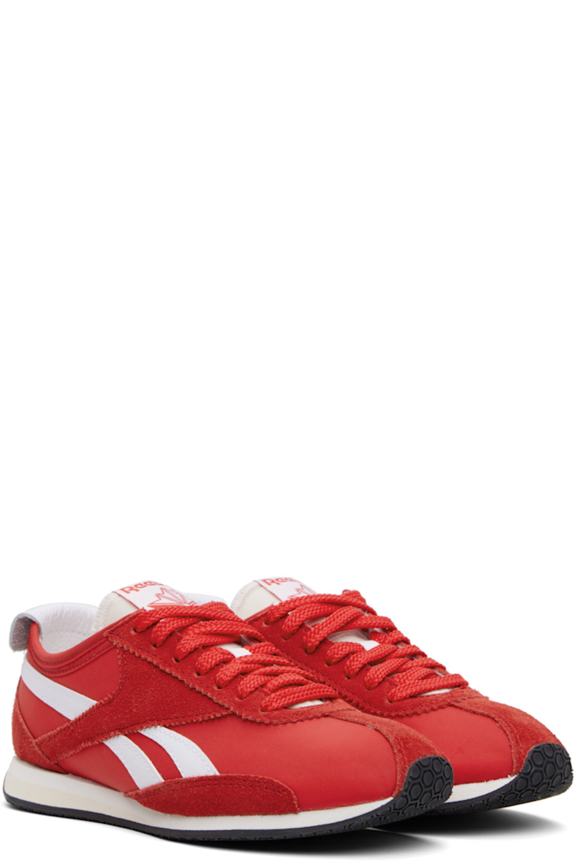 Low-top canvas and suede sneakers in red.

· Serrated edge at lace-up closure
· Logo patch at padded tongue
· Padded collar
· Signature stripes at sides
· Logo printed at leather foldover heel tab
· Jersey lining 
· Treaded rubber sole

Supplier color: Vector red/Vector red/White