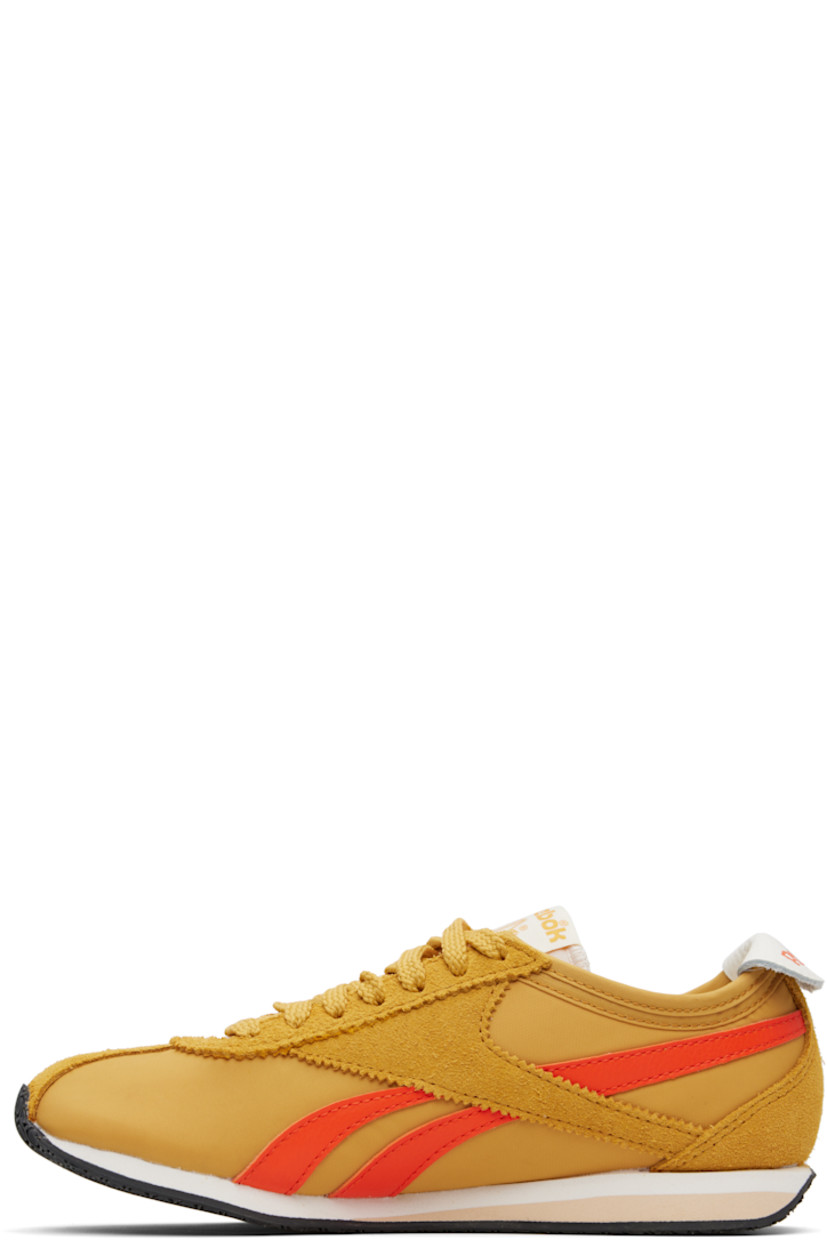 Low-top canvas and suede sneakers in yellow.

· Serrated edge at lace-up closure
· Logo patch at padded tongue
· Padded collar
· Signature stripes at sides
· Logo printed at leather foldover heel tab
· Jersey lining 
· Treaded rubber sole

Supplier color: Grit gold/Pump orange/Chalk