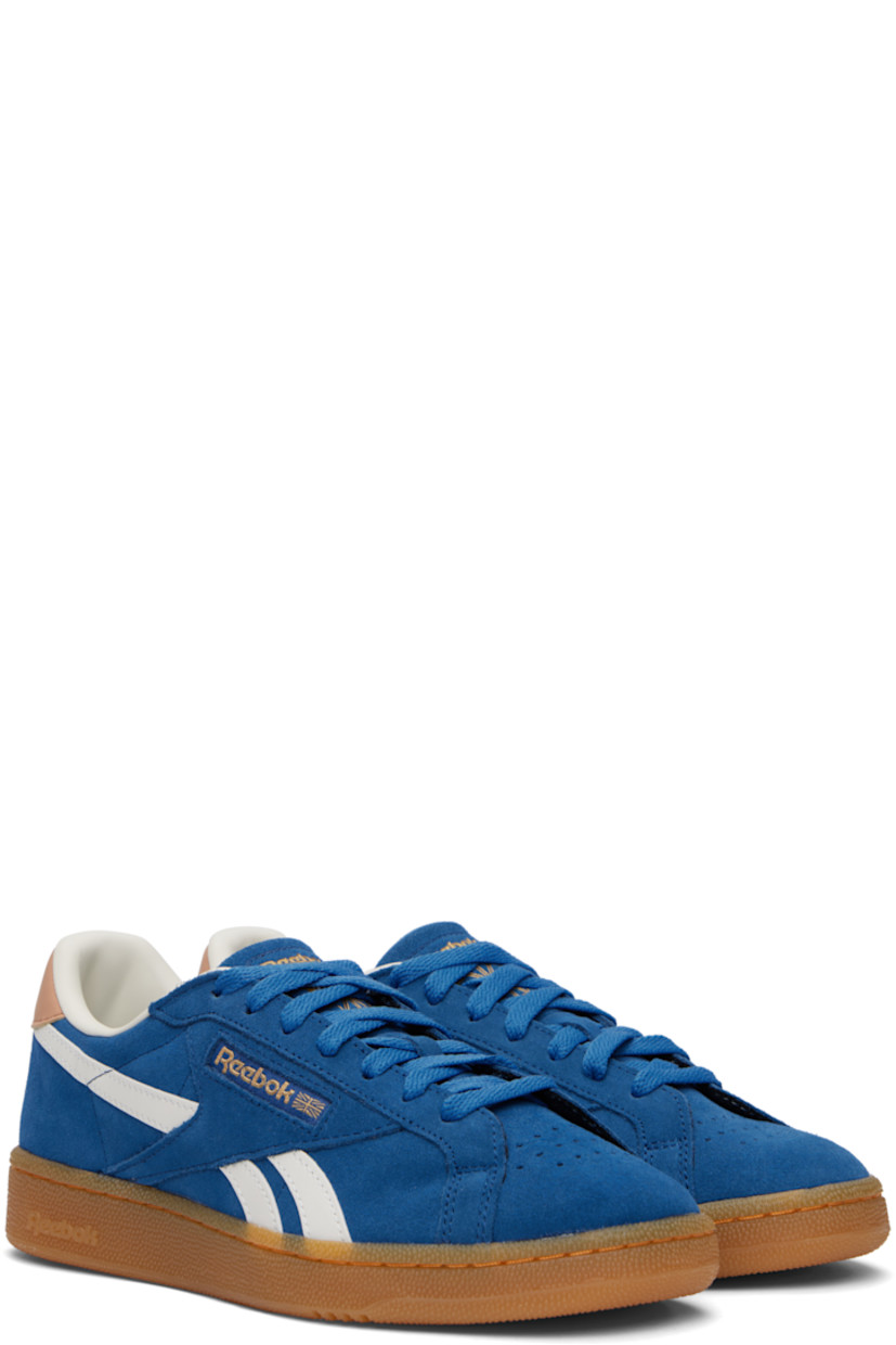 Low-top suede sneakers in blue.

· Perforated detailing at toe
· Lace-up closure
· Logo embossed at padded tongue
· Padded collar
· Inset logo patch at outer side
· Signature stripes at sides
· Logo printed at heel tab
· Grained leather lining
· Treaded rubber sole

Supplier color: Twilightblue/Clay/Chalk