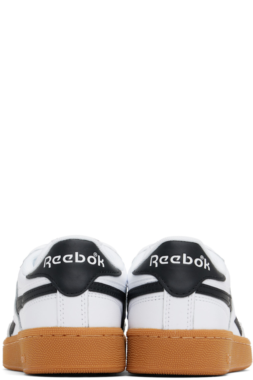 Low-top buffed leather sneakers in white and black.

· Suede trim at toe
· Perforated detailing at vamp
· Lace-up closure
· Logo patch at padded tongue
· Padded collar
· Inset logo patch at outer side
· Signature stripes at sides
· Logo printed at heel tab
· Terry cloth lining
· Treaded rubber sole

Supplier color: White/Black/Gum