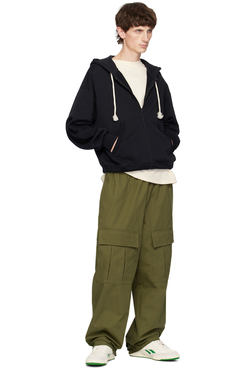 Low-top buffed leather sneakers in off-white and green.

· Suede trim at toe
· Perforated detailing at vamp
· Lace-up closure
· Logo patch at padded tongue
· Padded collar
· Inset logo patch at outer side
· Signature stripes at sides
· Logo printed at heel tab
· Terry cloth lining
· Treaded rubber sole

Supplier color: Chalk/Papwht/Glegrn