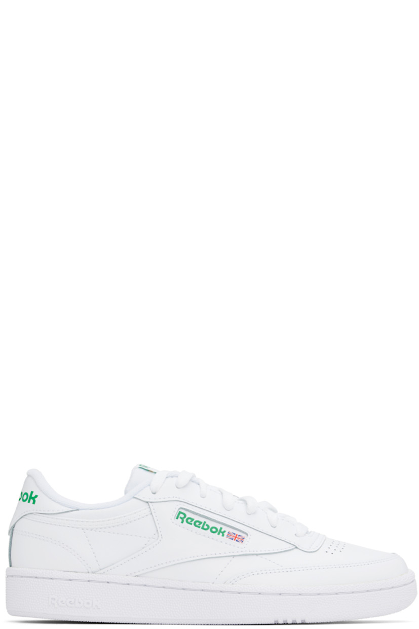 Low-top buffed leather sneakers in white.

· Perforated detailing at vamp
· Lace-up closure
· Logo patch at padded tongue
· Padded collar
· Inset logo patch at outer side
· Logo printed at heel tab
· Terry cloth lining
· Foam rubber midsole
· Treaded rubber sole

Supplier color: Int white/Green