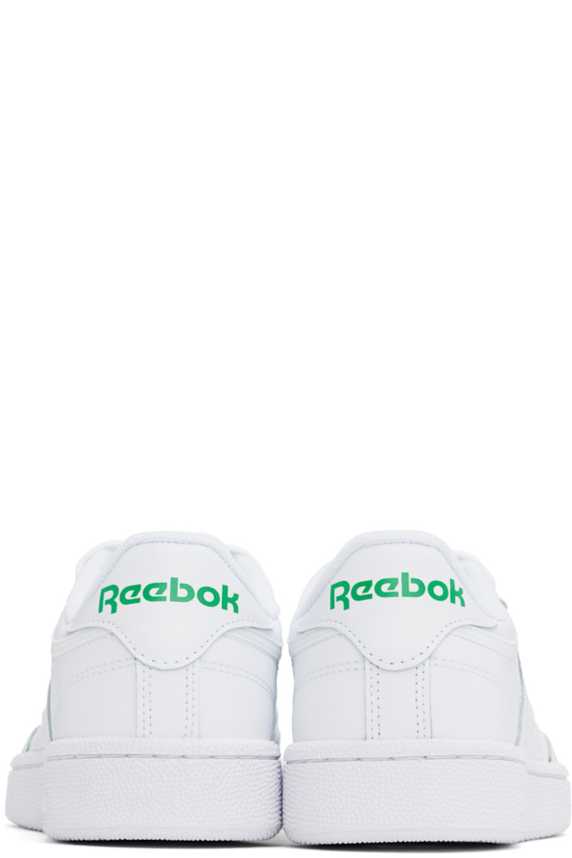 Low-top buffed leather sneakers in white.

· Perforated detailing at vamp
· Lace-up closure
· Logo patch at padded tongue
· Padded collar
· Inset logo patch at outer side
· Logo printed at heel tab
· Terry cloth lining
· Foam rubber midsole
· Treaded rubber sole

Supplier color: Int white/Green