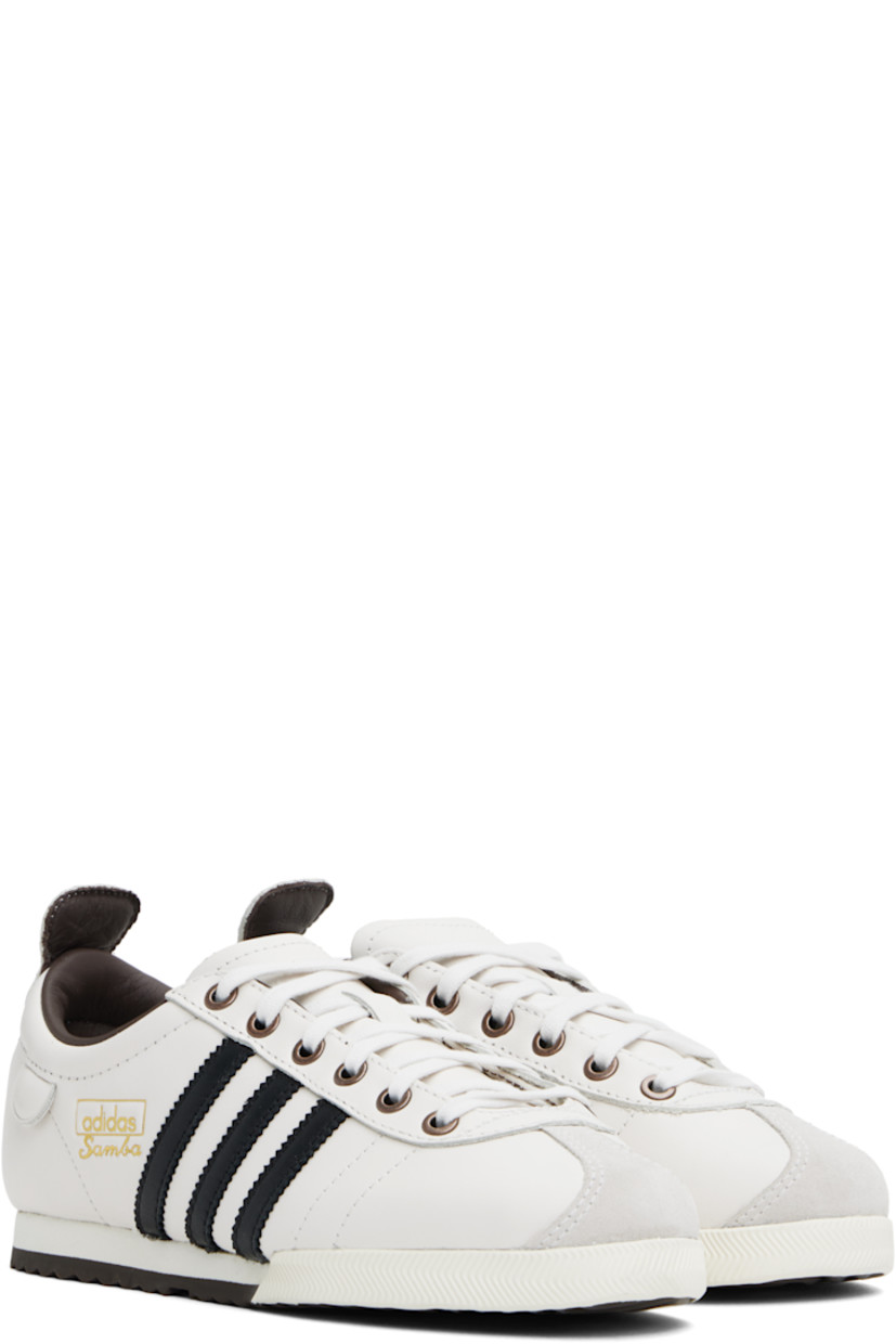 Low-top buffed leather sneakers in off-white.

· Suede trim at toe
· Lace-up closure
· Padded collar
· Signature serrated stripes at sides
· Pull-tab at sides and heel collar
· Logo stamp at outer side
· Grained leather lining
· Foam rubber midsole
· Treaded rubber sole

Supplier color: Cloud white/Core black/Brown