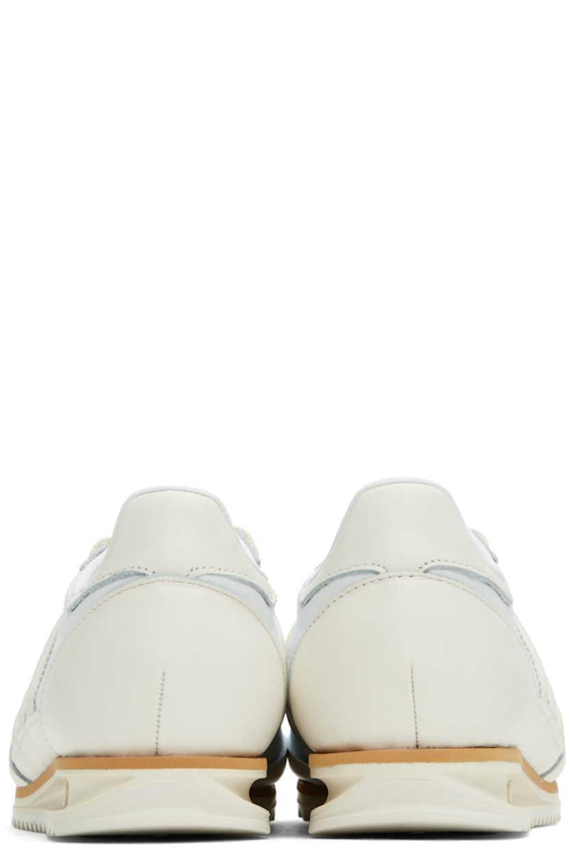 Low-top mesh, grained leather, and buffed leather sneakers off-white and white.

· Lace-up closure
· Logo bonded at tongue
· Padded collar
· Signature serrated stripes at sides
· Buffed faux-leather and mesh lining
· Logo embossed at foam rubber midsole
· Treaded rubber sole

Supplier color: Cloud white/Off white/Gum