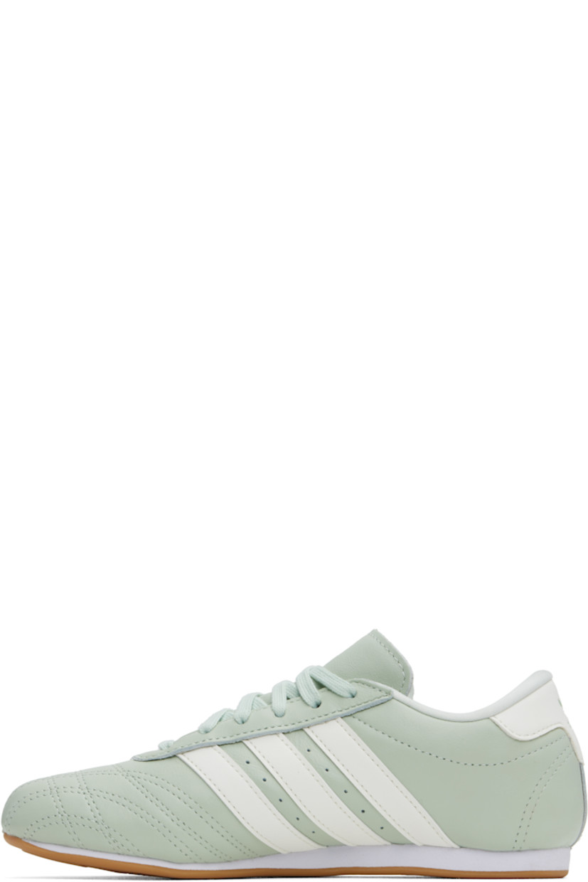 Low-top grained leather sneakers in green.

· Quilting at toe
· Lace-up closure
· Logo printed at padded tongue
· Padded collar
· Perforations and signature stripes at sides
· Logo embossed at heel tab
· Jersey lining
· Treaded rubber sole

Supplier color: Linen green/Off white/Cloud white