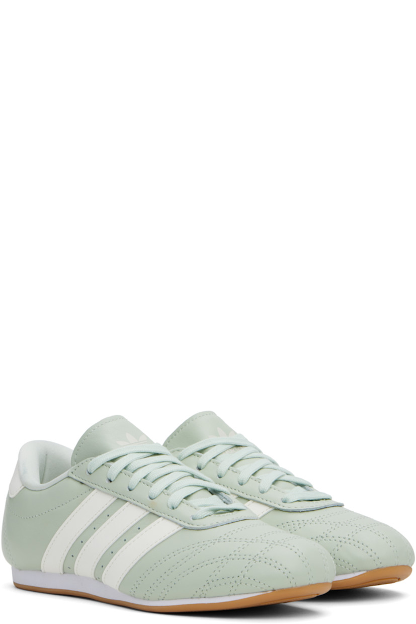 Low-top grained leather sneakers in green.

· Quilting at toe
· Lace-up closure
· Logo printed at padded tongue
· Padded collar
· Perforations and signature stripes at sides
· Logo embossed at heel tab
· Jersey lining
· Treaded rubber sole

Supplier color: Linen green/Off white/Cloud white