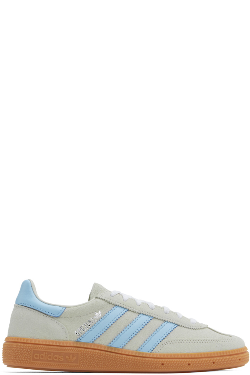 Low-top suede and buffed leather sneakers in gray and blue.

· Lace-up closure
· Logo patch at padded tongue
· Padded collar
· Signature serrated stripes at sides
· Logo stamp at outer side
· Buffed faux-leather and mesh lining
· Logo embossed at textured rubber midsole
· Treaded rubber sole

Supplier color: Alumina/Clear sky/Gum