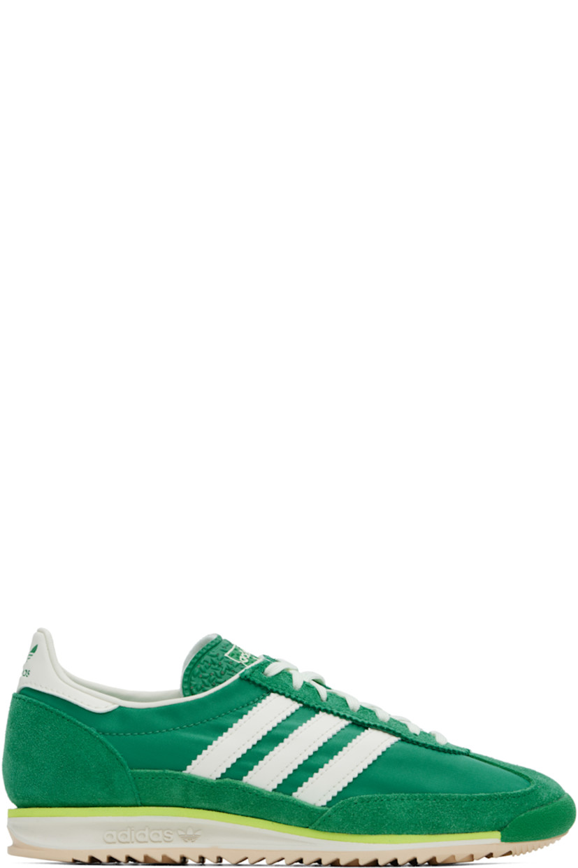 Low-top canvas and suede sneakers in green.

· Lace-up closure
· Logo printed at textured tongue
· Padded heel collar
· Signature serrated stripes at sides
· Logo embossed at buffed leather heel tab
· Buffed faux-leather and mesh lining
· Logo embossed at foam rubber midsole
· Treaded rubber sole

Supplier color: Court green/Ivory/Crystal sand