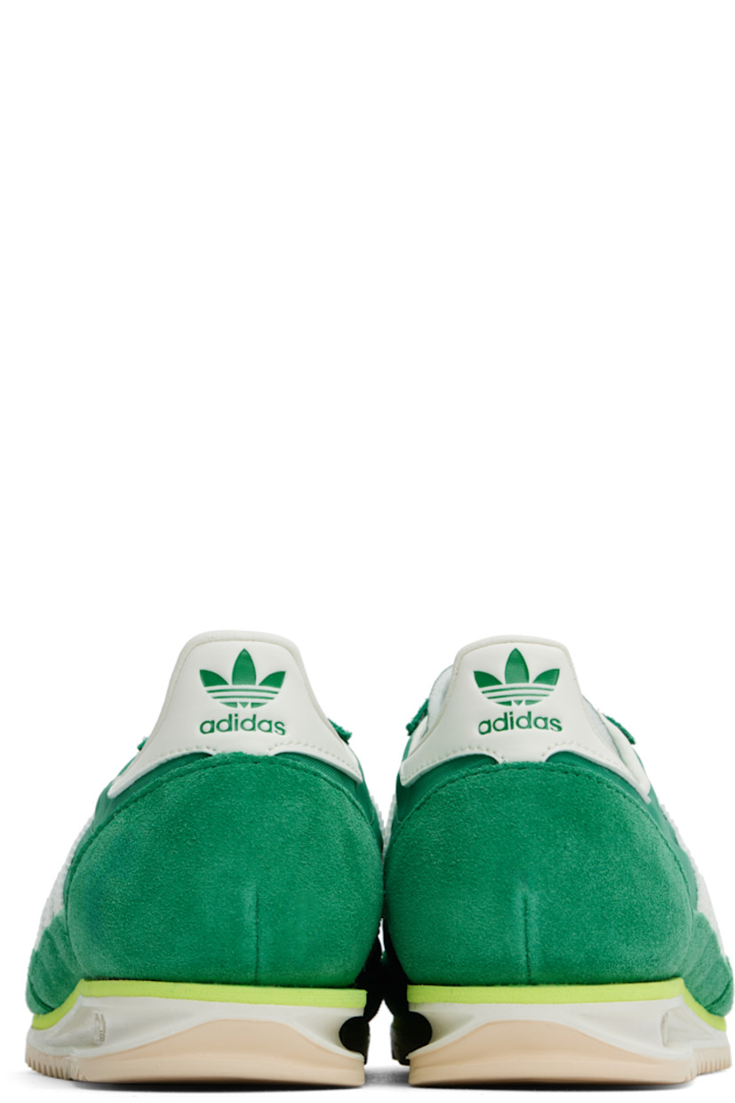 Low-top canvas and suede sneakers in green.

· Lace-up closure
· Logo printed at textured tongue
· Padded heel collar
· Signature serrated stripes at sides
· Logo embossed at buffed leather heel tab
· Buffed faux-leather and mesh lining
· Logo embossed at foam rubber midsole
· Treaded rubber sole

Supplier color: Court green/Ivory/Crystal sand