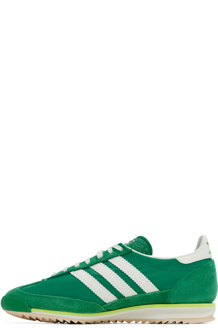 Low-top canvas and suede sneakers in green.

· Lace-up closure
· Logo printed at textured tongue
· Padded heel collar
· Signature serrated stripes at sides
· Logo embossed at buffed leather heel tab
· Buffed faux-leather and mesh lining
· Logo embossed at foam rubber midsole
· Treaded rubber sole

Supplier color: Court green/Ivory/Crystal sand