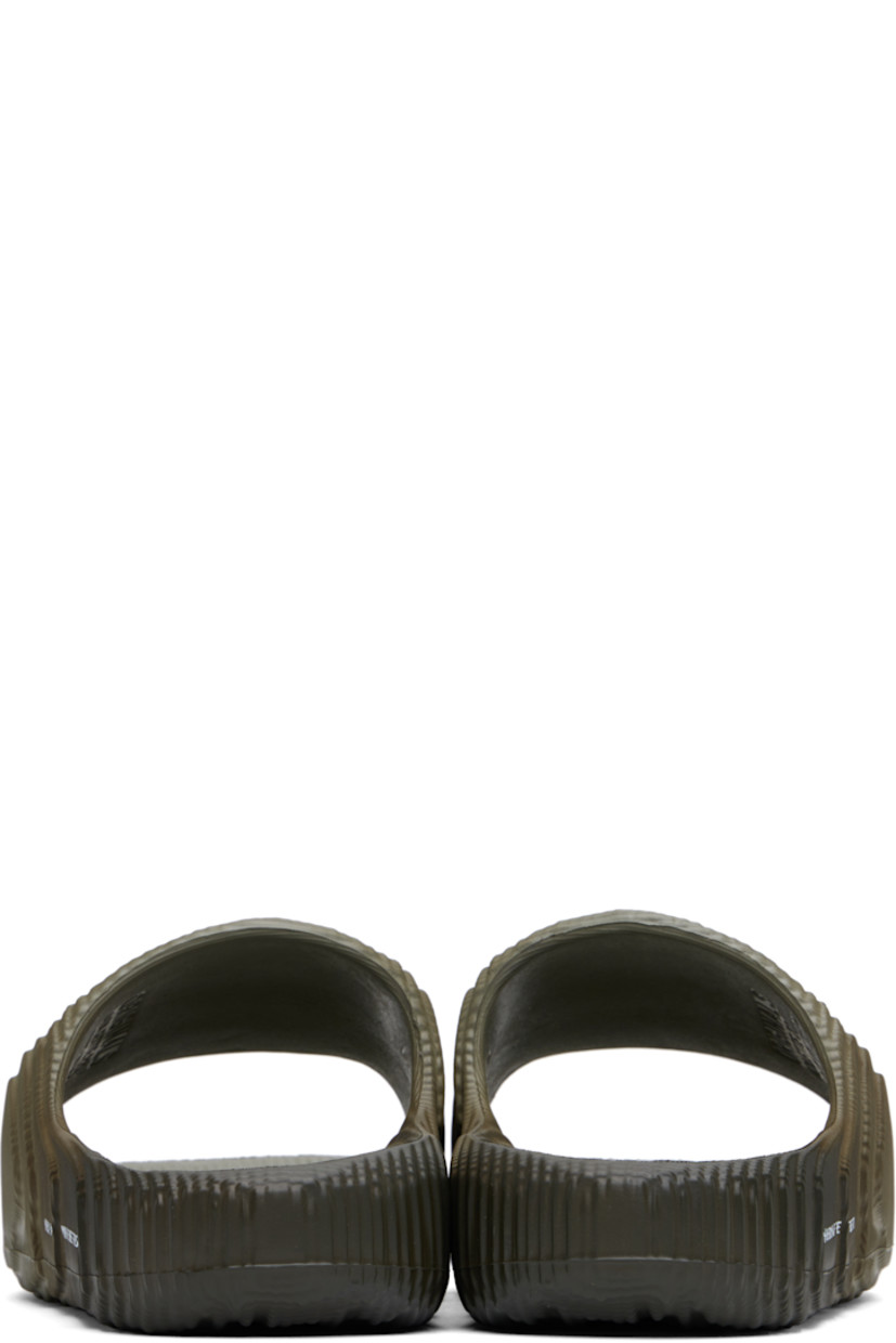 Textured foam rubber slides in gray.

· Gradient pattern printed throughout
· Open toe
· Logo and text printed at outer side
· Logo embossed at molded rubber footbed
· Treaded rubber sole

Supplier color: Silver pebble/Shadow olive/Off white