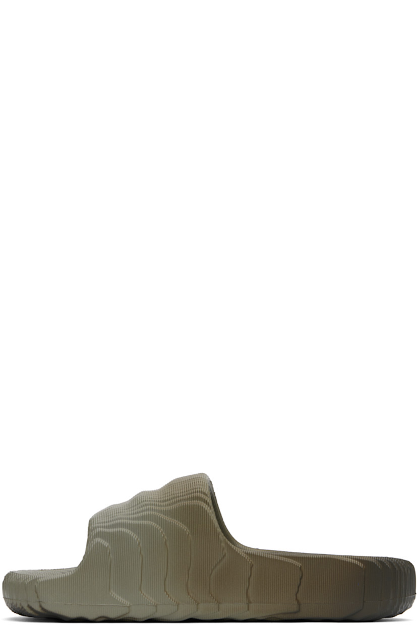 Textured foam rubber slides in gray.

· Gradient pattern printed throughout
· Open toe
· Logo and text printed at outer side
· Logo embossed at molded rubber footbed
· Treaded rubber sole

Supplier color: Silver pebble/Shadow olive/Off white