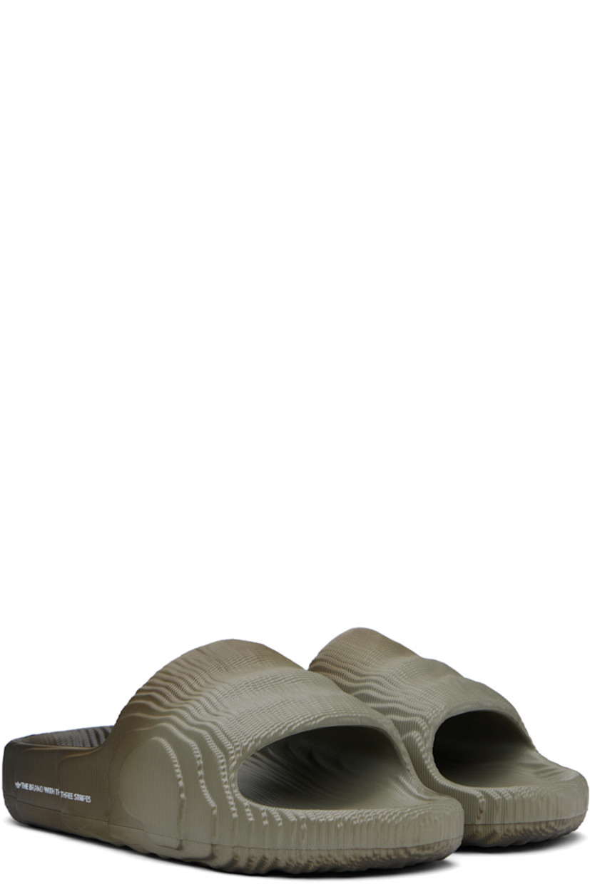 Textured foam rubber slides in gray.

· Gradient pattern printed throughout
· Open toe
· Logo and text printed at outer side
· Logo embossed at molded rubber footbed
· Treaded rubber sole

Supplier color: Silver pebble/Shadow olive/Off white