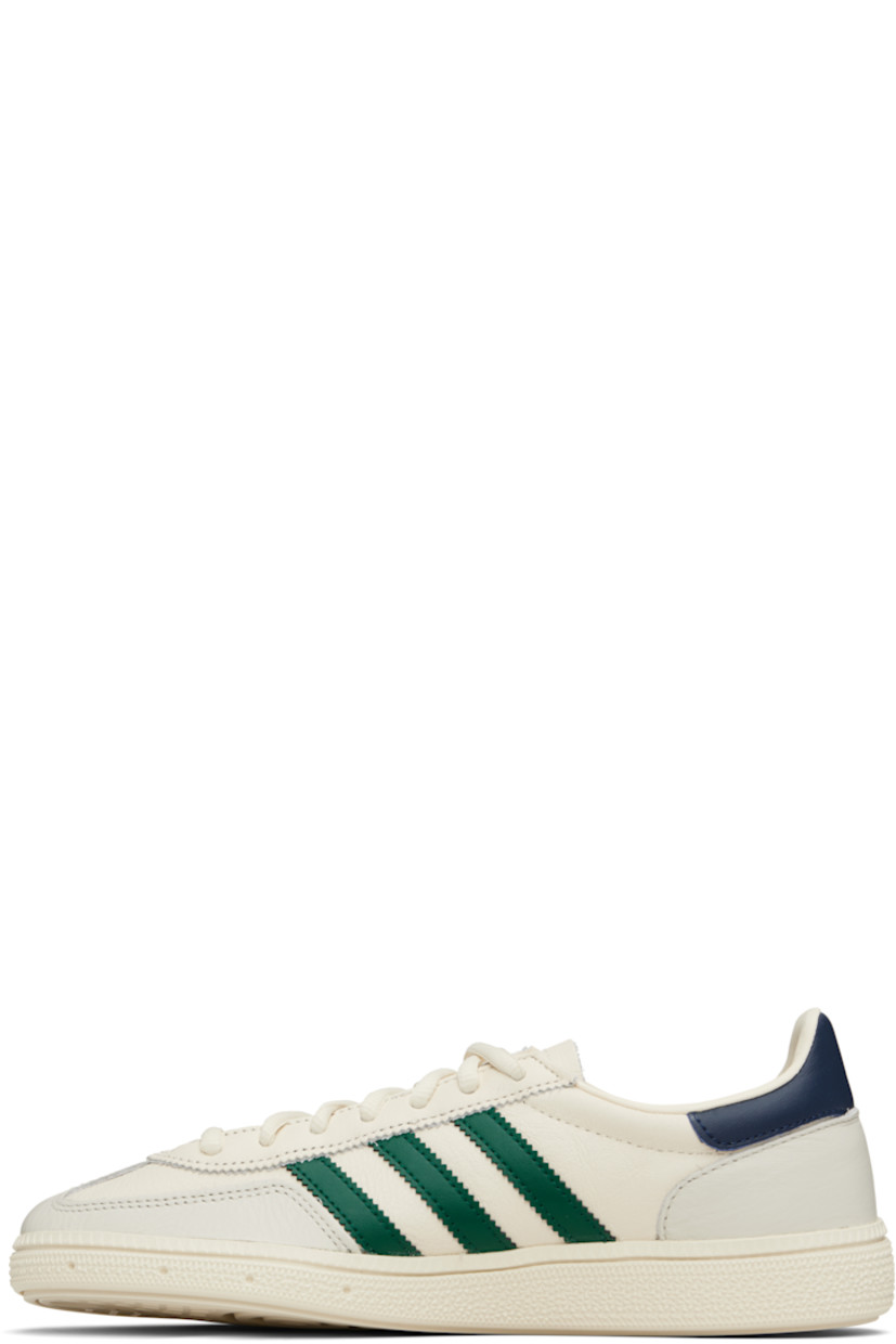 Low-top grained leather sneakers.

· Lace-up closure
· Logo patch at tongue
· Padded collar
· Signature serrated stripes at sides
· Text stamped at outer side
· Mesh lining
· Logo embossed at textured rubber midsole
· Treaded rubber sole

Supplier color: Chalk white/Collegiate green/Night indigo