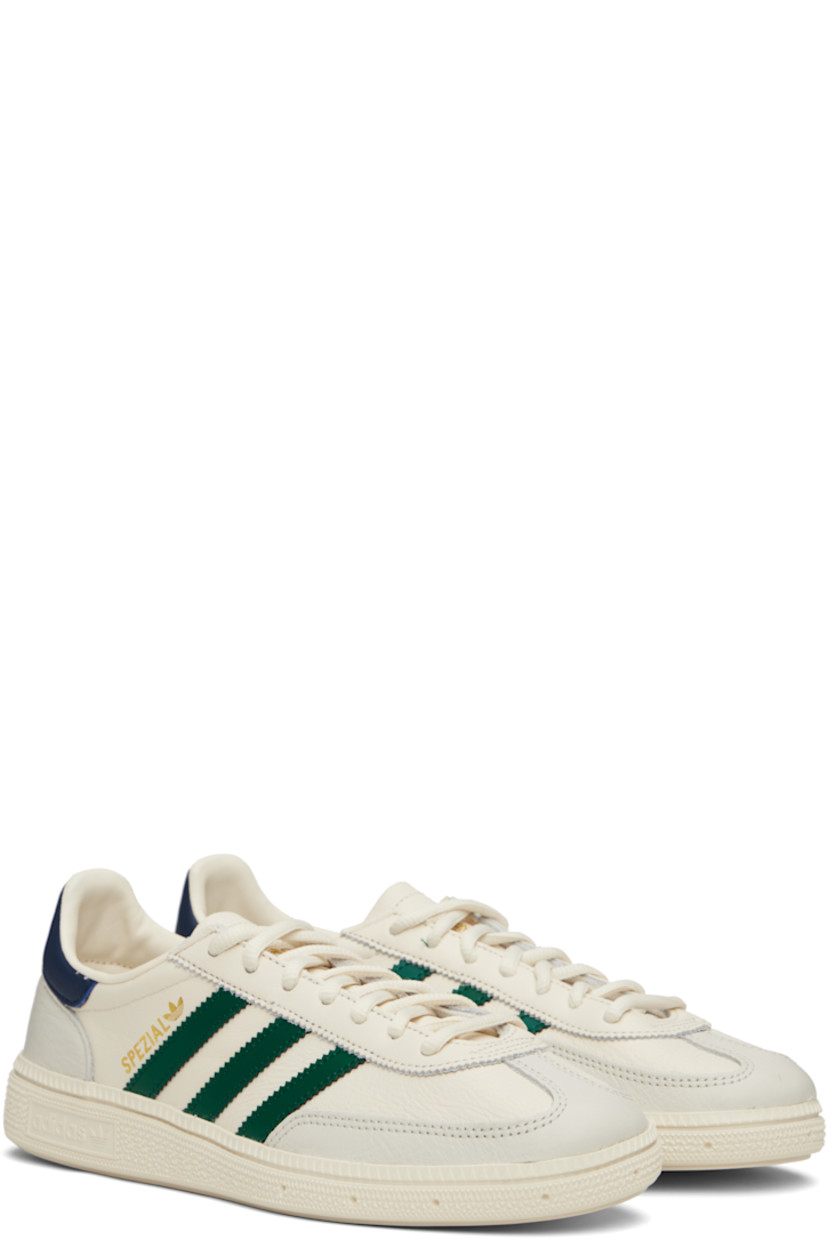 Low-top grained leather sneakers.

· Lace-up closure
· Logo patch at tongue
· Padded collar
· Signature serrated stripes at sides
· Text stamped at outer side
· Mesh lining
· Logo embossed at textured rubber midsole
· Treaded rubber sole

Supplier color: Chalk white/Collegiate green/Night indigo