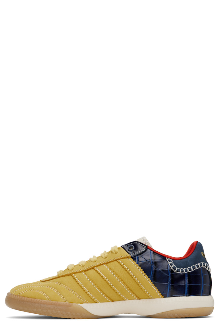 Low-top paneled suede and croc-embossed leather sneakers in yellow and navy.

· Lace-up closure
· Logo patch at padded tongue
· Padded collar
· Serrated signature stripes at sides
· Blanket stitching and logo embossed at heel tab
· Satin lining
· Treaded Torsion System® rubber sole
· Contrast stitching in white

Part of the Wales Bonner x adidas Originals collaboration.

Supplier color: St fade gold/St fade gold/Collegiate navy