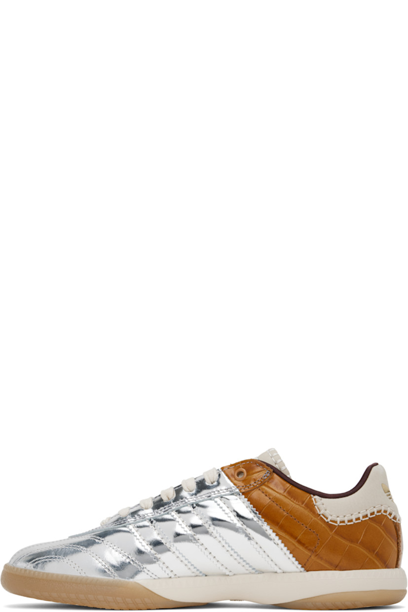 Low-top paneled lamé and croc-embossed leather sneakers in silver tone and brown. 

· Lace-up closure
· Logo patch at padded tongue
· Padded collar
· Serrated signature stripes at sides
· Blanket stitching and logo embossed at suede heel tab
· Satin lining
· Treaded Torsion System® rubber sole
· Contrast stitching in white

Part of the Wales Bonner x adidas Originals collaboration.

Supplier color: Silver metallic/Silver metallic/Easy yellow