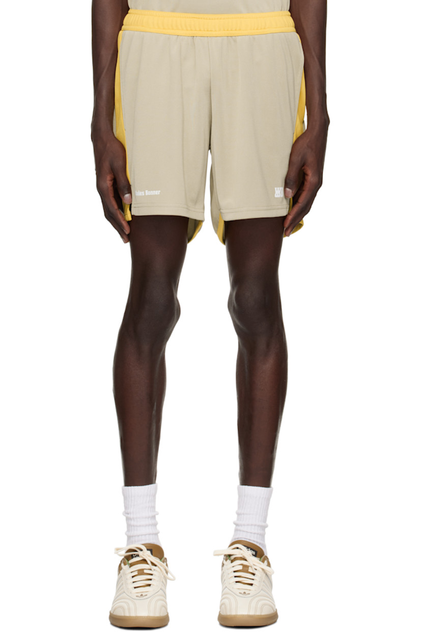 Polyester interlock jersey shorts.

· Colorblocked construction
· Concealed drawstring at elasticized waistband
· Two-pocket styling
· Logo printed at cuffs
· Vented outseams

Supplier color: Beige/Yellow