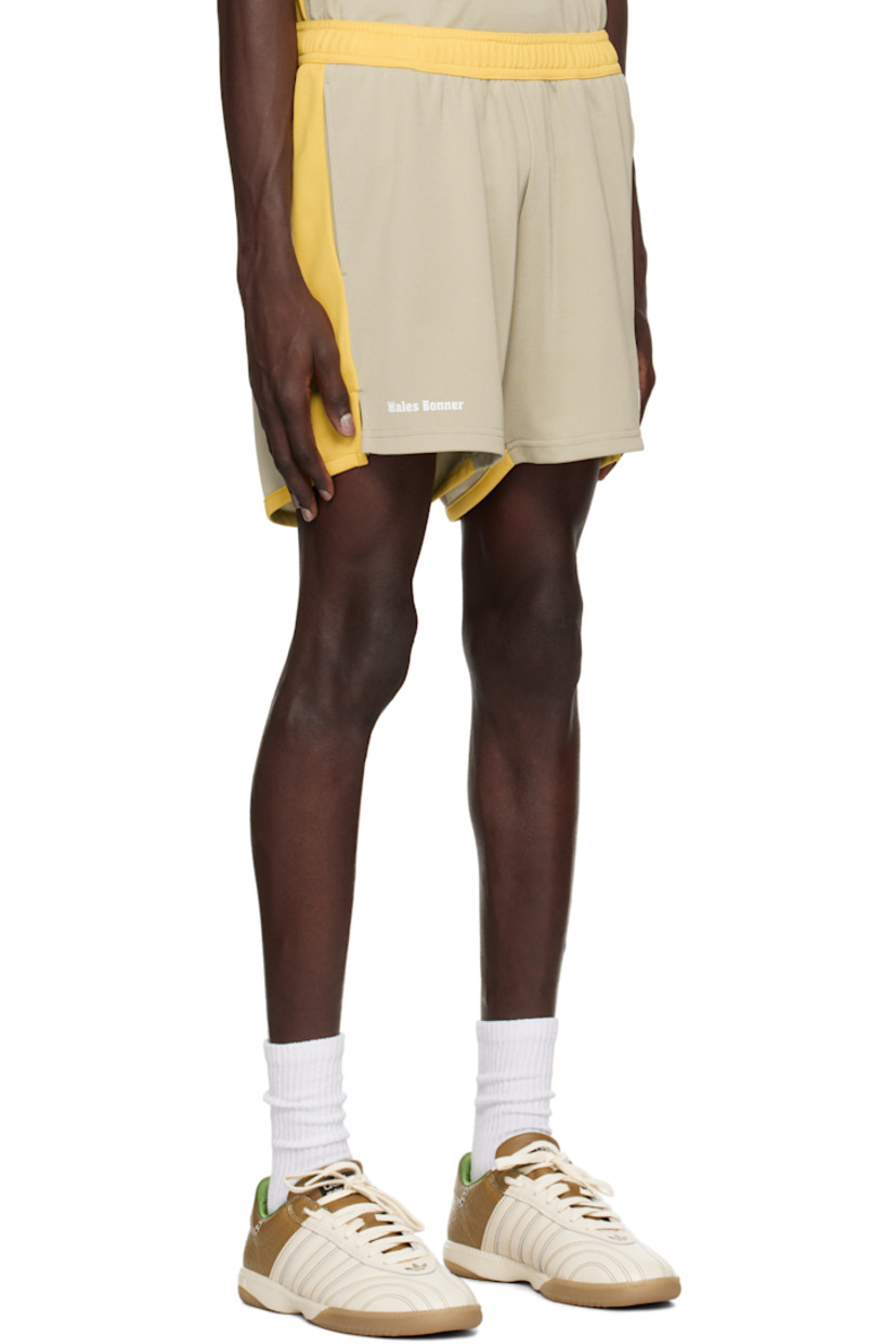 Polyester interlock jersey shorts.

· Colorblocked construction
· Concealed drawstring at elasticized waistband
· Two-pocket styling
· Logo printed at cuffs
· Vented outseams

Supplier color: Beige/Yellow