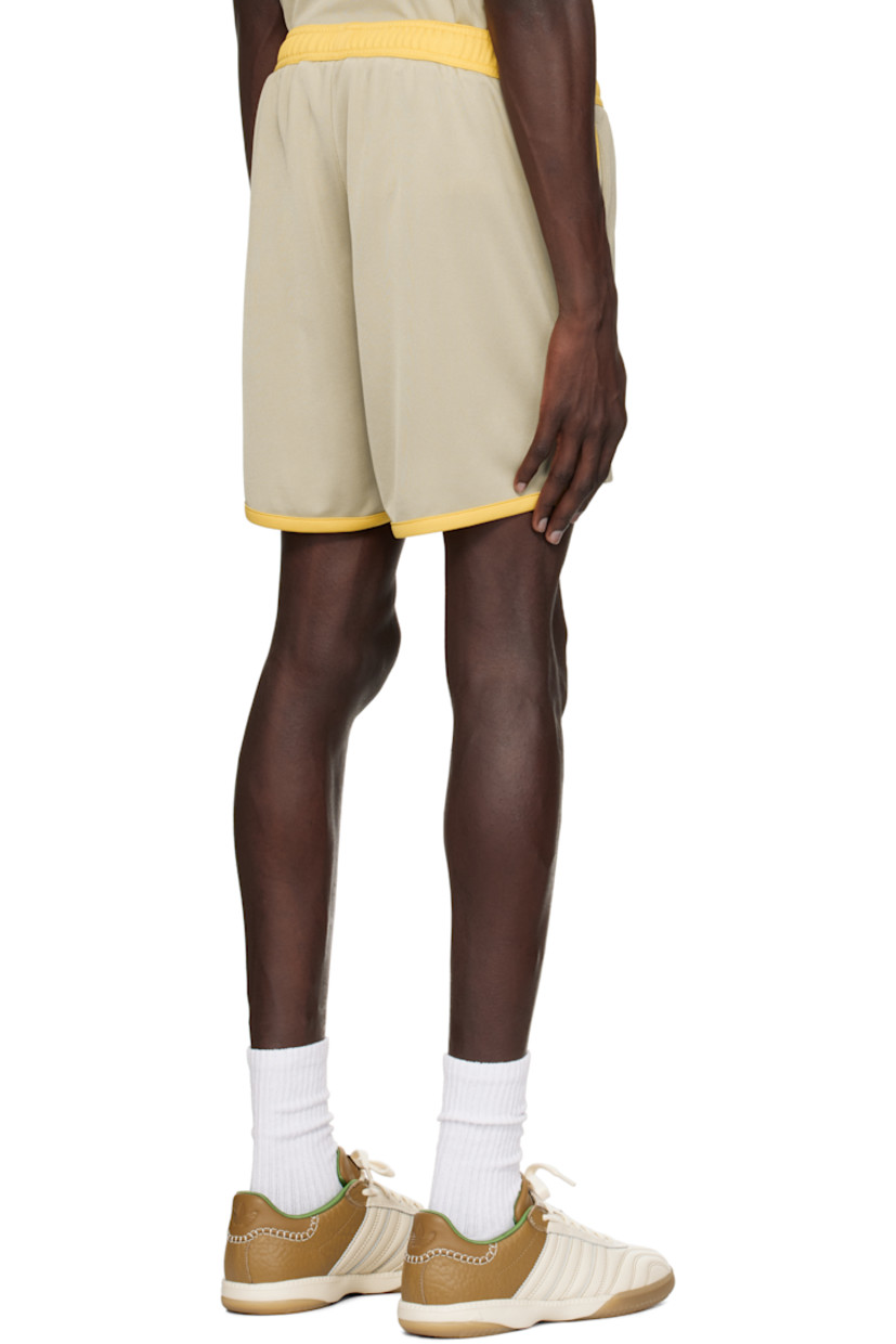Polyester interlock jersey shorts.

· Colorblocked construction
· Concealed drawstring at elasticized waistband
· Two-pocket styling
· Logo printed at cuffs
· Vented outseams

Supplier color: Beige/Yellow