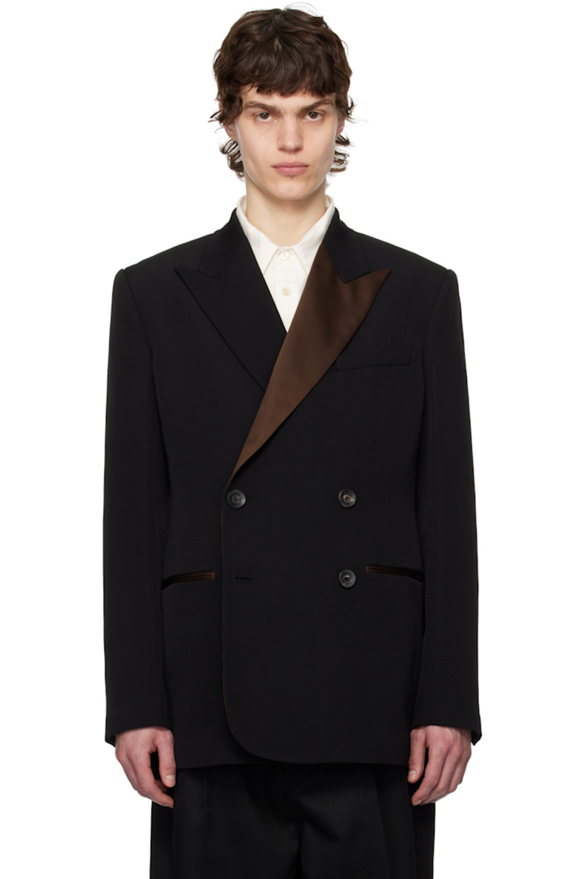Wool grain de poudre blazer. 

· Satin panel at peaked lapel
· Double-breasted closure
· Welt pockets
· Padded shoulders 
· Three-button surgeon's cuffs
· Central vent at back hem
· Welt pocket at interior
· Fully lined
· Horn hardware 

Supplier color: Black
