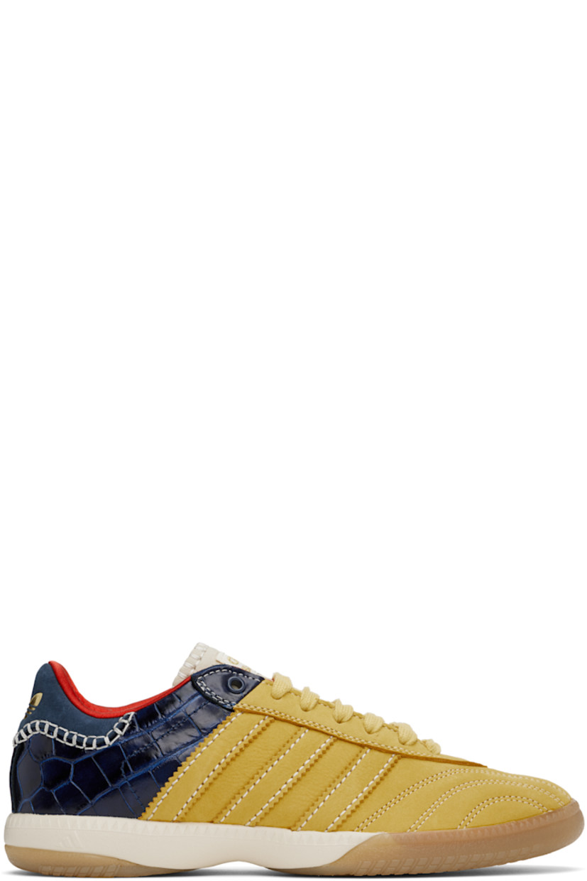 Low-top paneled suede and croc-embossed leather sneakers in yellow and navy.

· Lace-up closure
· Logo patch at padded tongue
· Padded collar
· Serrated signature stripes at sides
· Blanket stitching and logo embossed at heel tab
· Satin lining
· Treaded Torsion System® rubber sole
· Contrast stitching in white

Part of the Wales Bonner x adidas Originals collaboration.

Supplier color: St fade gold/St fade gold/Collegiate navy