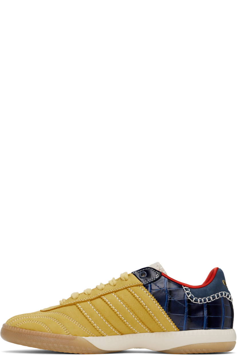Low-top paneled suede and croc-embossed leather sneakers in yellow and navy.

· Lace-up closure
· Logo patch at padded tongue
· Padded collar
· Serrated signature stripes at sides
· Blanket stitching and logo embossed at heel tab
· Satin lining
· Treaded Torsion System® rubber sole
· Contrast stitching in white

Part of the Wales Bonner x adidas Originals collaboration.

Supplier color: St fade gold/St fade gold/Collegiate navy