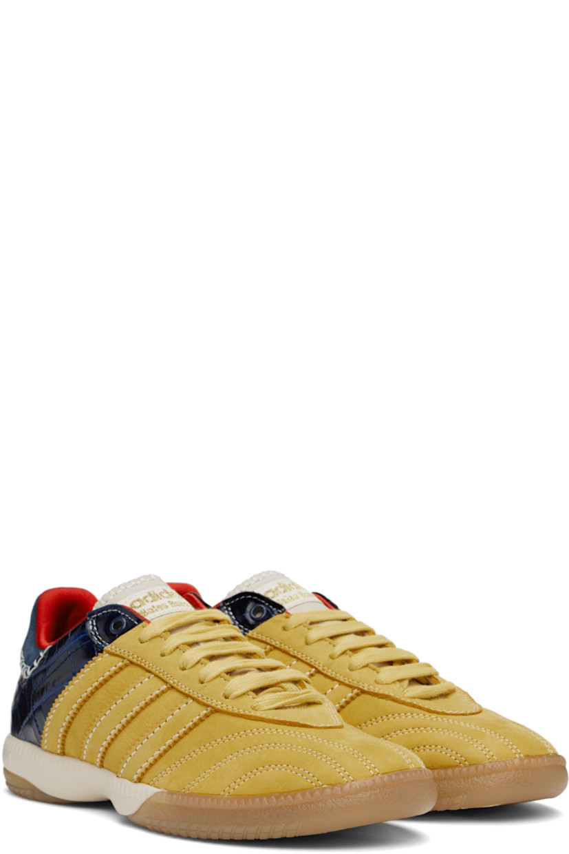 Low-top paneled suede and croc-embossed leather sneakers in yellow and navy.

· Lace-up closure
· Logo patch at padded tongue
· Padded collar
· Serrated signature stripes at sides
· Blanket stitching and logo embossed at heel tab
· Satin lining
· Treaded Torsion System® rubber sole
· Contrast stitching in white

Part of the Wales Bonner x adidas Originals collaboration.

Supplier color: St fade gold/St fade gold/Collegiate navy