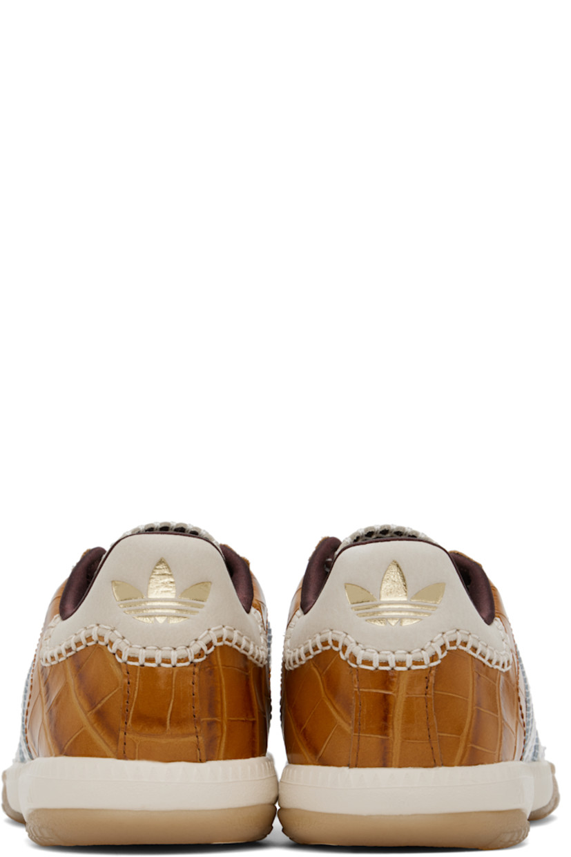 Low-top paneled lamé and croc-embossed leather sneakers in silver tone and brown. 

· Lace-up closure
· Logo patch at padded tongue
· Padded collar
· Serrated signature stripes at sides
· Blanket stitching and logo embossed at suede heel tab
· Satin lining
· Treaded Torsion System® rubber sole
· Contrast stitching in white

Part of the Wales Bonner x adidas Originals collaboration.

Supplier color: Silver metallic/Silver metallic/Easy yellow