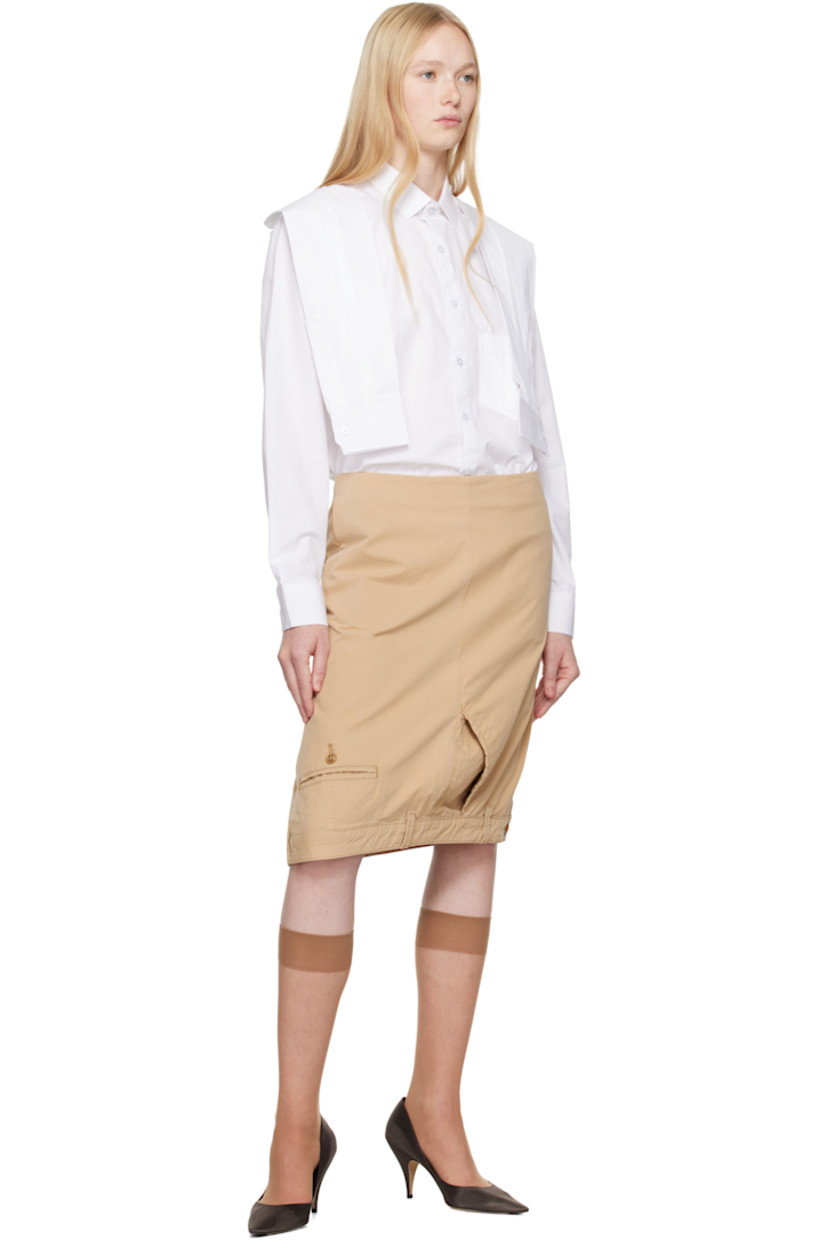 Stretch cotton twill midi skirt.

· Two-pocket styling
· Welt pockets at front and back
· Belt loops and button fastening at hem
· Zip vent at side seam
· Zip closure at back

Each item is constructed using upcycled garments. Please note colorways may vary.