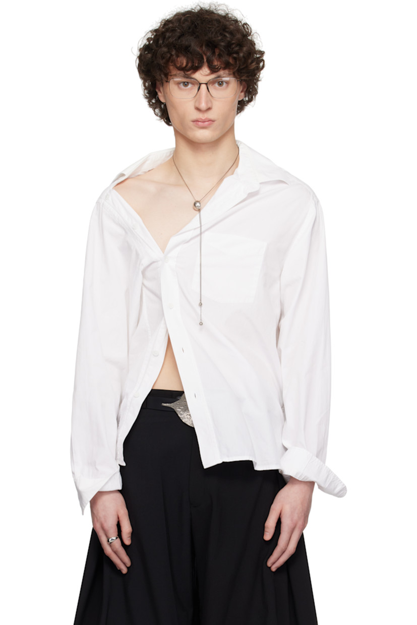 Cotton poplin shirt.

· Asymmetrical construction
· Spread collar
· Offset button closure
· Patch pocket at chest
· Shirttail hem
· Adjustable buttoned barrel cuffs
· Pleats and logo-woven locker loop at back yoke

Each item is constructed using upcycled garments. Please note colorways may vary.